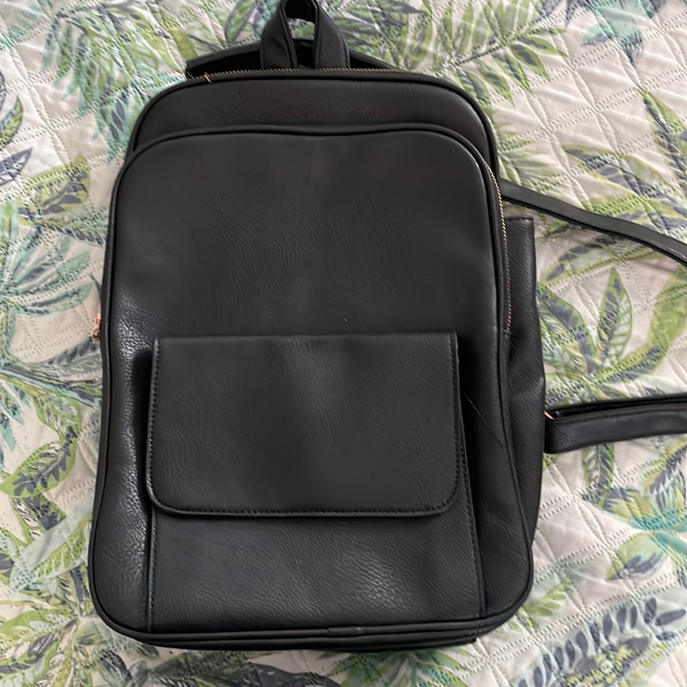 Black leather small backpack. Strap can change to crossover or purse.